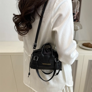 Mini black lychee texture shell bag with top handles and adjustable shoulder strap