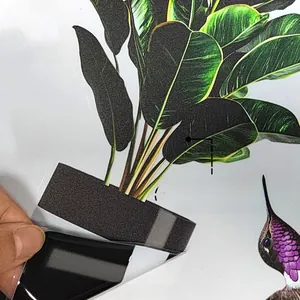 Close-up of double-sided leaf and hummingbird window stickers with magnetic backing