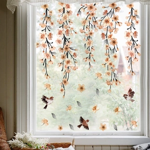 Detail of static cling window film featuring ink-style floral branches and brown birds