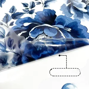 Detail of self-adhesive blue floral wall sticker being peeled to show removable backing