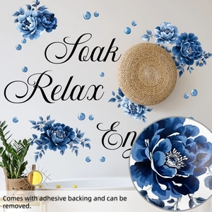 Close-up of blue floral wall stickers with Soak Relax Enjoy text and adhesive detail