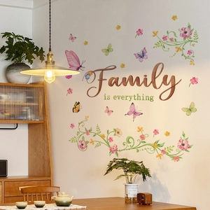 Detail of floral vine wall decals with Family is Everything text and colorful butterflies