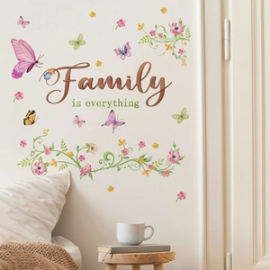 Detailed view of Family is Everything lettering with pink floral vines and butterfly decals