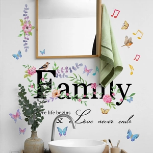 Detail showing 'Family' wall stickers with flowers, birds and butterflies on white wall