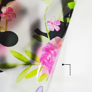 Close-up of floral wall decal showing frosted texture and adhesive backing for easy removal