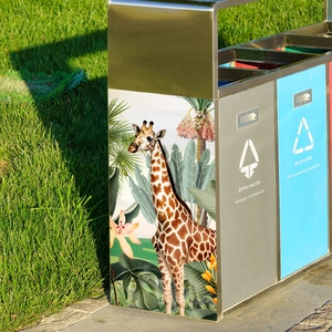 Close-up of tropical giraffe and palm leaf decorative sticker on a stainless steel bin