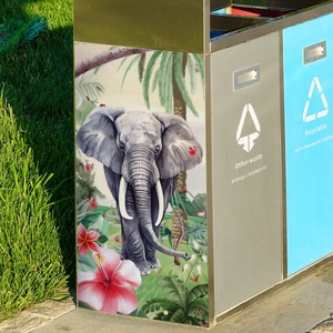 Detail view of elephant and floral painted patterns on a stainless steel sorting bin