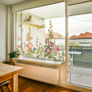 Detailed watercolor flower and butterfly static window film applied on a bright home window