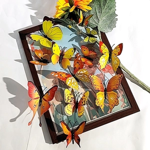 Detailed view of 3D gold butterfly wall stickers with realistic patterns and vibrant warm colors