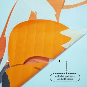 Close-up of double-sided cartoon fox window sticker showing colorful patterns on both sides