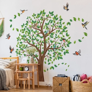 Detail of vibrant green tree and colorful birds wall decals in a cozy bedroom setting