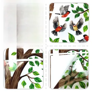 Detail view of bird and leaf wall decals showing both front side and adhesive back side