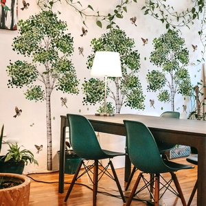 Detail of birch tree wall stickers with green leaves and flying birds in a home office