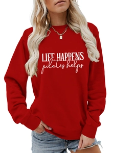Detail of red crewneck sweatshirt with white Life Happens Pilates Helps text print