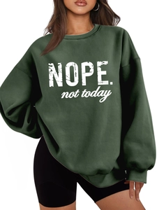 Detail of white NOPE. not today artistic print on dark green oversized fleece sweatshirt