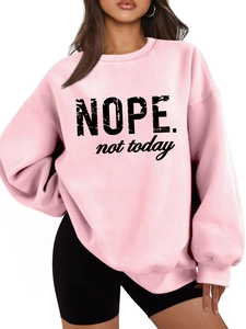 Close-up of pink oversized sweatshirt featuring black NOPE not today artistic lettering