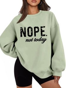 Close-up of light green fleece sweatshirt with black NOPE not today printed slogan