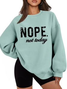 Close-up of Nope not today slogan print on mint green fleece-lined sweatshirt