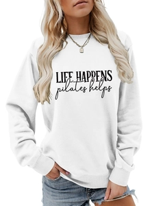 Detail of the Life Happens Pilates Helps slogan on a white long sleeve sweatshirt