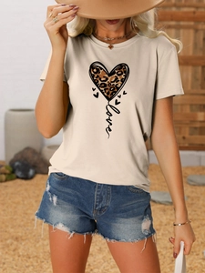 Close-up of beige round-neck t-shirt featuring a leopard print heart and Love text