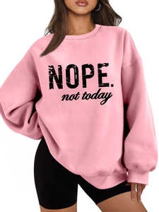 Detailed view of pink sweatshirt with NOPE not today slogan and soft fleece texture