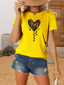 Detail of yellow round neck T-shirt with leopard print heart and artistic love lettering