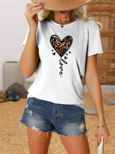 Detail of leopard print heart and love graphic on a white short sleeve t-shirt