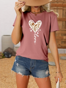 Detail of love leopard print on casual pink t-shirt paired with denim shorts
