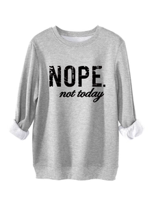 Detail of grey sweatshirt with 'NOPE.' text showing warm white fleece lining on sleeve