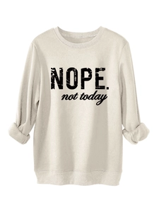 Close-up of Nope Not Today black lettering on soft cream-colored fleece sweatshirt