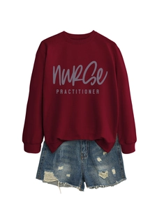 Flat lay of a dark red sweatshirt with nurse practitioner print and denim shorts