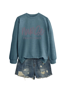 Detail of blue Nurse Practitioner sweatshirt paired with distressed denim shorts