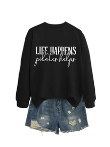 Detail of Pilates helps quote on black crewneck sweatshirt with distressed denim shorts