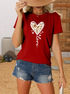 Detail of red crewneck T-shirt with leopard heart and Love print for casual summer style