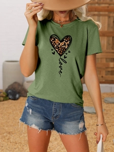 Detail of green T-shirt with leopard print heart and Love text in outdoor setting