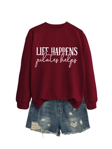 Burgundy sweatshirt with Life Happens Pilates Helps text paired with denim shorts
