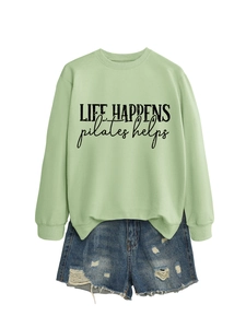 Mint green pullover with 'Life Happens Pilates Helps' print and distressed denim shorts