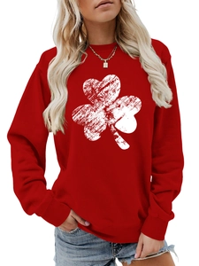 Detail of red crew neck sweatshirt with white distressed shamrock print on soft cotton fabric