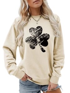 Detail of beige crewneck sweatshirt with distressed black shamrock print and ribbed cuffs