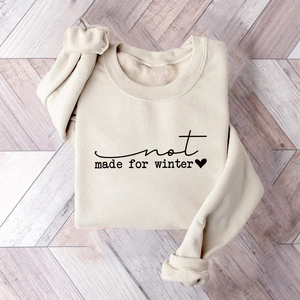 Detail of cream oversized fleece sweatshirt featuring black not made for winter slogan print