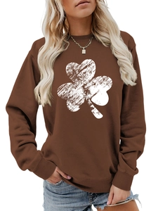 Close-up of brown long sleeve sweatshirt featuring white shamrock print and ribbed cuffs