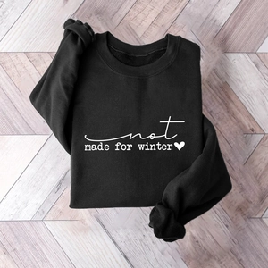 Close-up of black fleece sweatshirt featuring white not made for winter graphic print