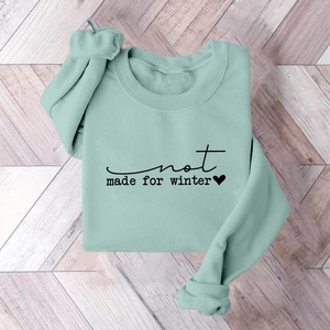 Detailed view of mint green fleece sweatshirt with black not made for winter print