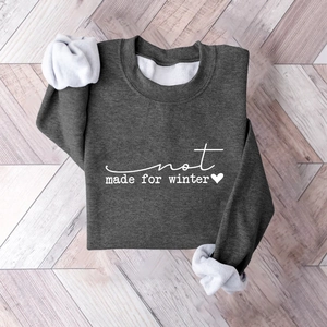 Detail of dark grey pullover sweatshirt featuring thick fleece lining and printed text design