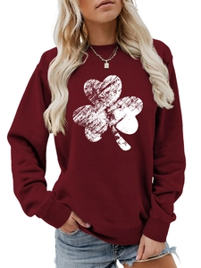 Close-up of ribbed cuffs and white shamrock print on the burgundy long sleeve sweatshirt