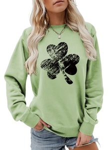 Detail of light green sweatshirt featuring vintage black clover print and ribbed cuffs