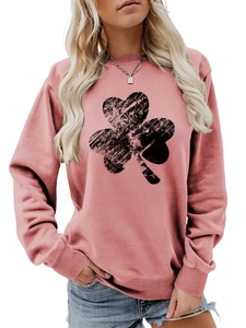 Detailed close-up of pink crewneck sweatshirt with distressed black shamrock print
