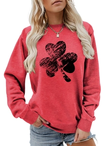 Detail of red crewneck sweatshirt featuring a black distressed shamrock print on cotton fabric