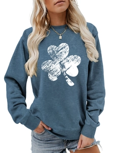 Detail of blue long-sleeve sweatshirt featuring a white distressed clover print pattern
