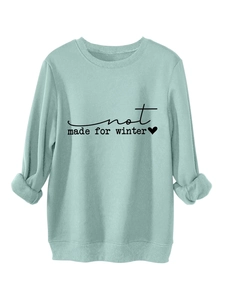 Detail of mint green sweatshirt cuff showing soft fleece lining and thick fabric texture